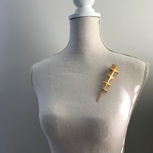 Gold colored lapel pin